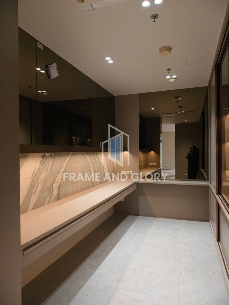 Modern retail storefront with wooden counter and black glass panel, featuring built-in lighting and polished concrete floor