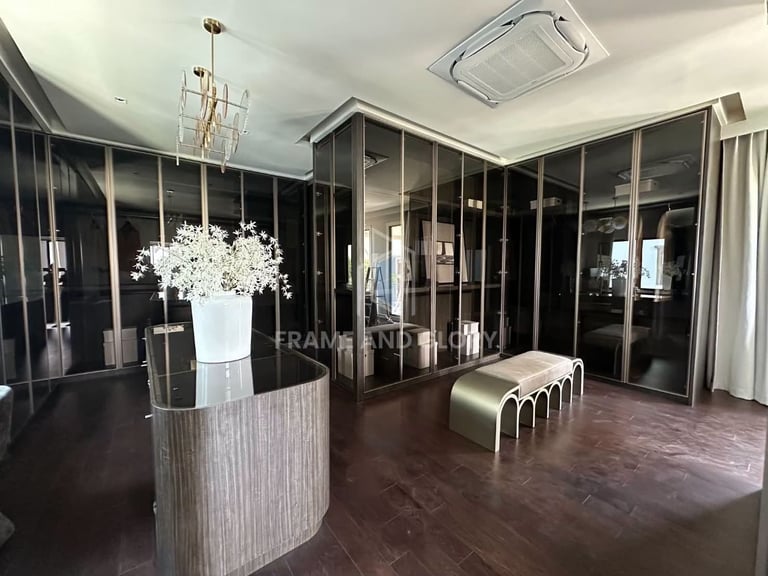 Modern showroom with black-framed glass partitions and dark wooden flooring