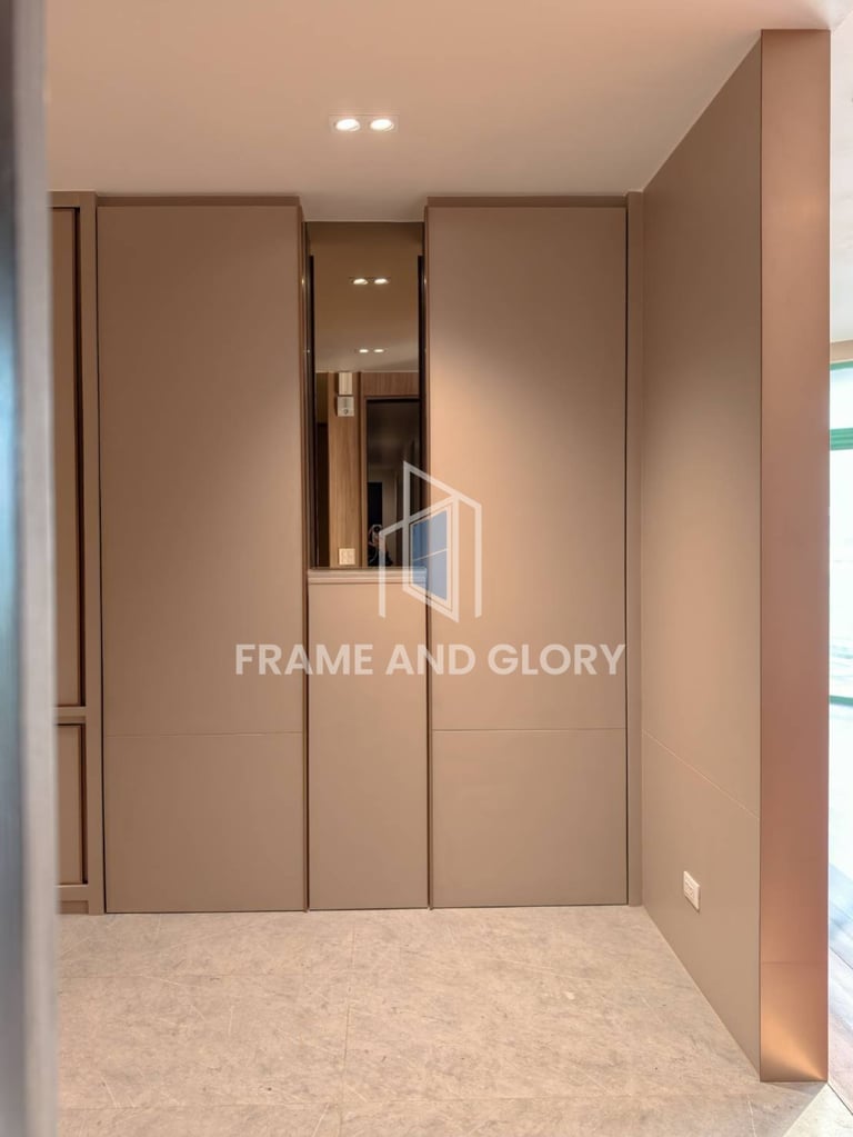 Modern wardrobe with mirrored sliding doors in a neutral bedroom with beige flooring and recessed ceiling lights