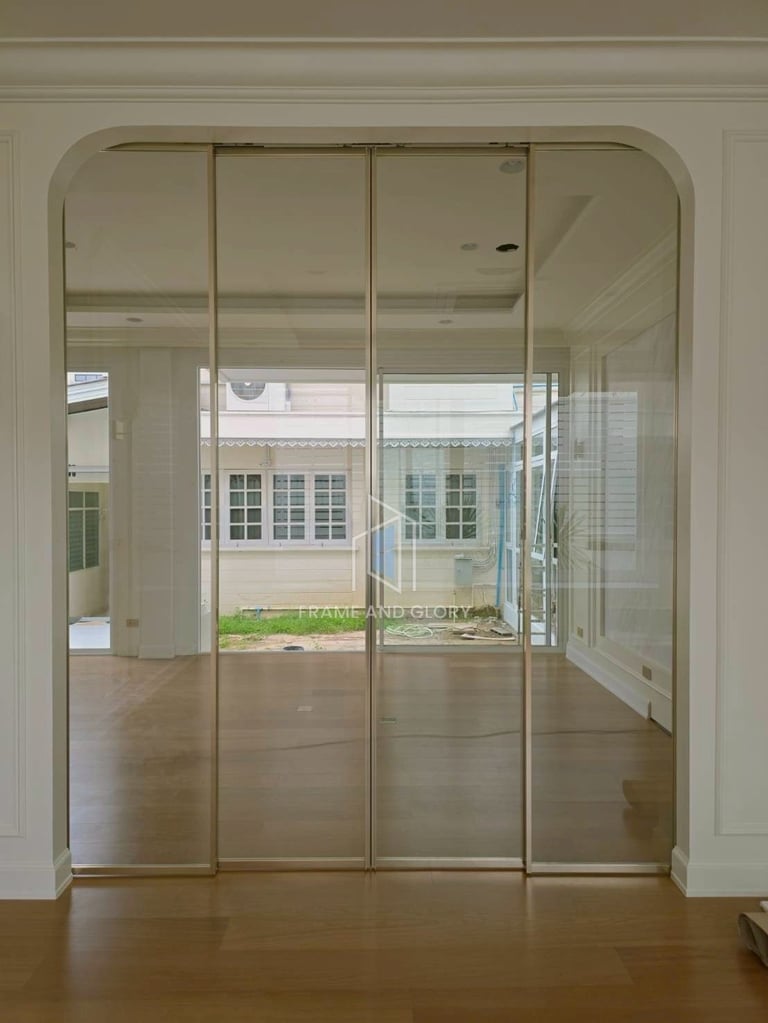 Glass sliding doors with four panels opening to a bright sunroom